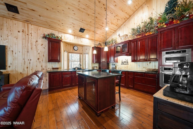 4683 Eagle Nest Ct, Lakeside, AZ 85929 - kitchen with reddish brown cabinets, wood ceiling, open floor plan, dark wood-type flooring, and a kitchen island
