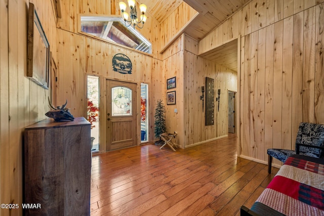4683 Eagle Nest Ct, Lakeside, AZ 85929 - entryway with wood walls, a chandelier, hardwood / wood-style floors, wood ceiling, and high vaulted ceiling