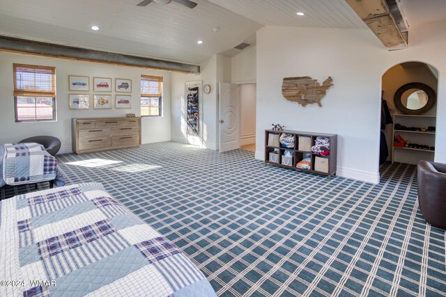 interior space featuring carpet floors, visible vents, arched walkways, and baseboards