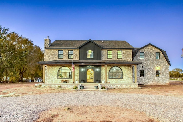 view of front of house with a porch and a chimney