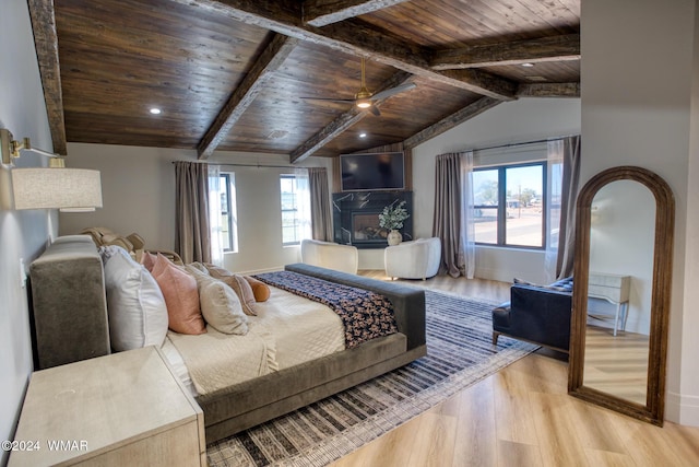 bedroom featuring vaulted ceiling with beams, light wood finished floors, and wood ceiling