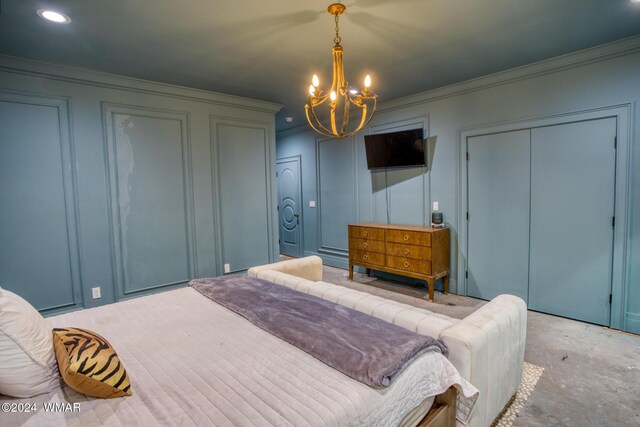 bedroom with ornamental molding, a notable chandelier, and a decorative wall