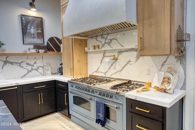 kitchen with open shelves, backsplash, light stone countertops, double oven range, and premium range hood