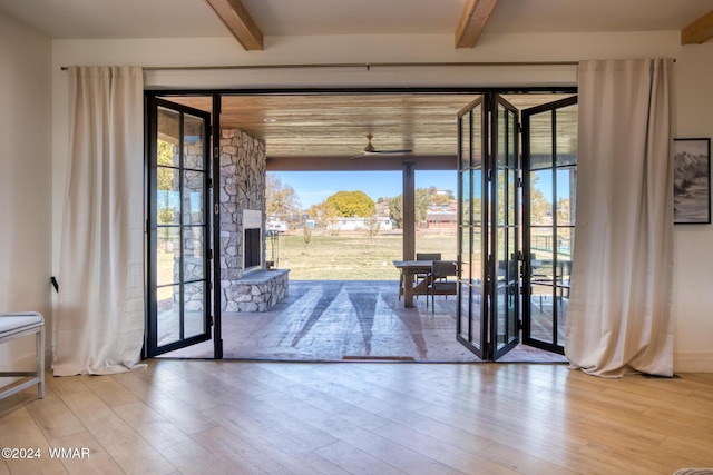 entryway featuring wood finished floors and beam ceiling