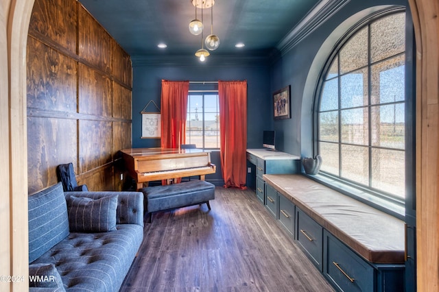 sitting room with crown molding and wood finished floors