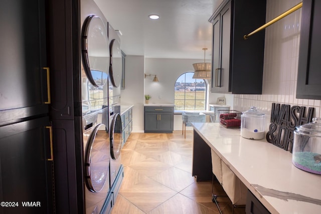 kitchen featuring refrigerator, pendant lighting, tasteful backsplash, recessed lighting, and gray cabinetry