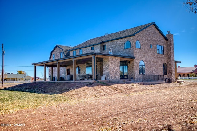 rear view of house with stone siding