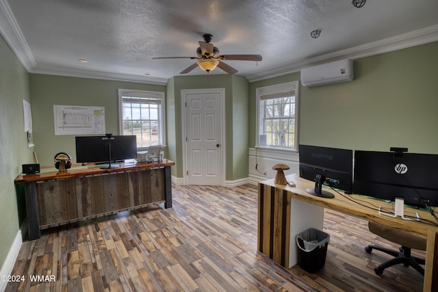 office space with ornamental molding, a healthy amount of sunlight, a wall mounted air conditioner, and wood finished floors