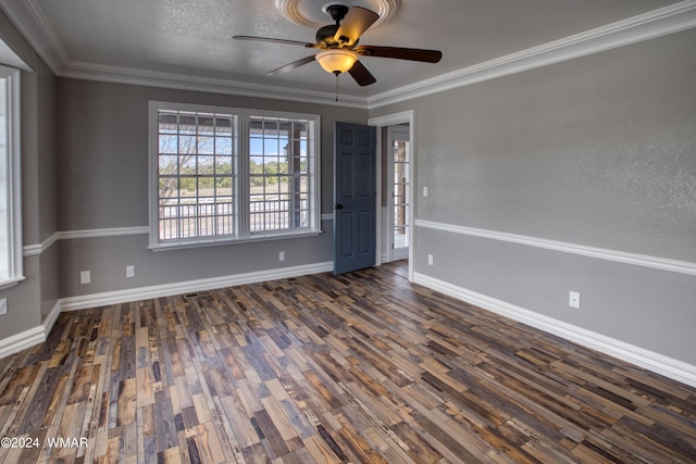 empty room with baseboards, ornamental molding, and dark wood-style flooring