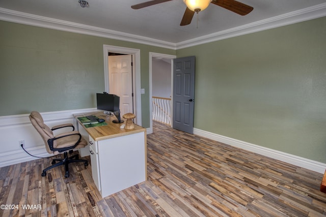 office space with ornamental molding, dark wood-type flooring, a ceiling fan, and baseboards