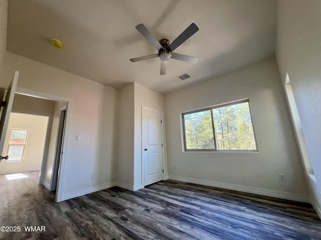 3131 State Route 277, Overgaard, AZ 85933 - unfurnished bedroom featuring dark wood-type flooring, baseboards, and a ceiling fan