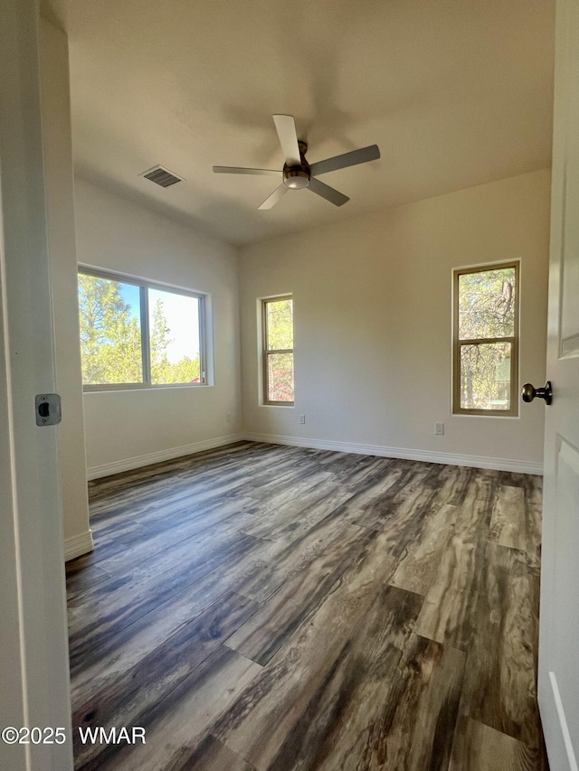 3131 State Route 277, Overgaard, AZ 85933 - empty room featuring dark wood-style floors, ceiling fan, healthy amount of natural light, and baseboards