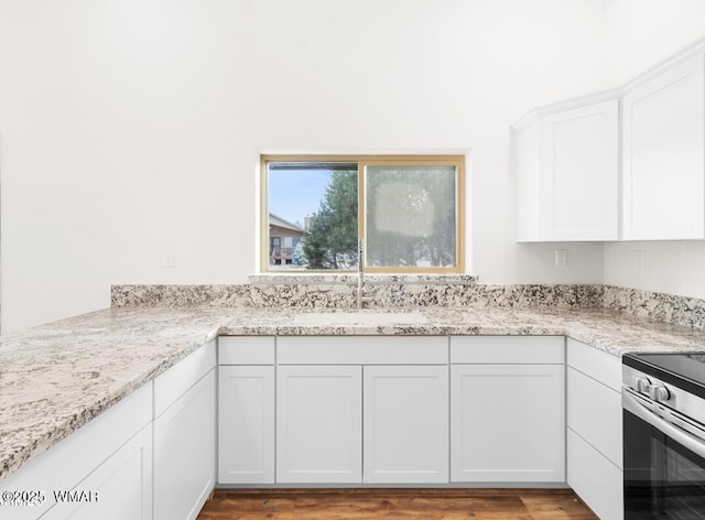 3131 State Route 277, Overgaard, AZ 85933 - kitchen featuring a sink, white cabinets, light stone countertops, and light wood finished floors