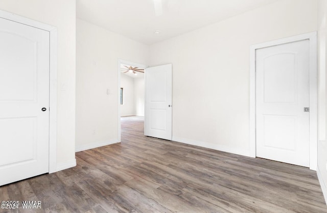 3131 State Route 277, Overgaard, AZ 85933 - unfurnished bedroom with wood finished floors, baseboards, and a ceiling fan