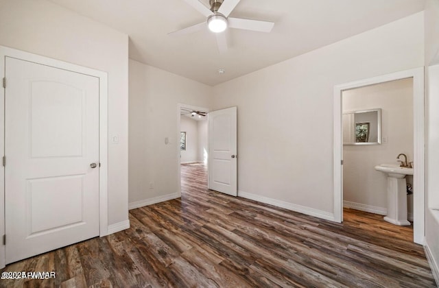 3131 State Route 277, Overgaard, AZ 85933 - unfurnished bedroom featuring dark wood-type flooring, baseboards, ensuite bath, a sink, and a ceiling fan