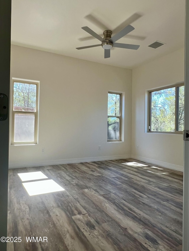 3131 State Route 277, Overgaard, AZ 85933 - empty room featuring healthy amount of natural light, ceiling fan, wood finished floors, and baseboards