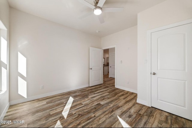 3131 State Route 277, Overgaard, AZ 85933 - unfurnished bedroom with wood finished floors, baseboards, and ceiling fan