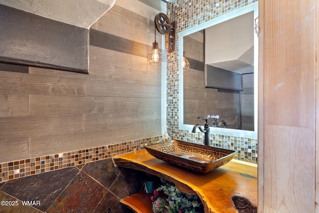 bathroom with backsplash and a sink