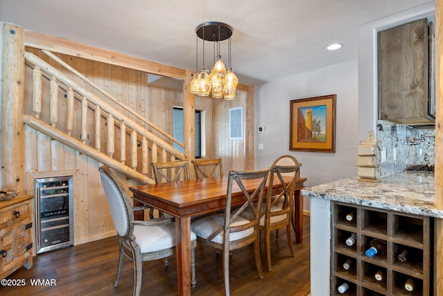 dining room featuring dark wood finished floors, recessed lighting, stairway, wine cooler, and baseboards