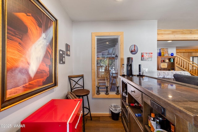 interior space featuring stairway, baseboards, and dark wood-type flooring