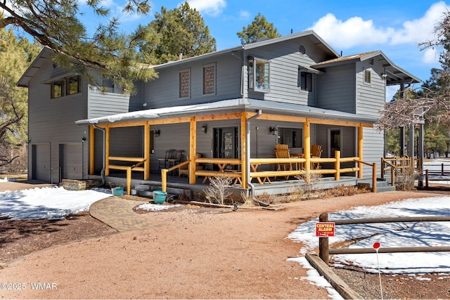 view of front facade with a garage and a porch