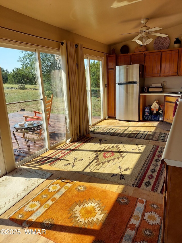 1949 Norton Pl, Show Low, AZ 85901 - kitchen with freestanding refrigerator, a ceiling fan, light countertops, and brown cabinetry
