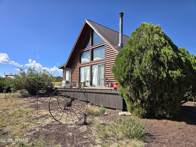 1949 Norton Pl, Show Low, AZ 85901 - view of side of property with log veneer siding and a metal roof