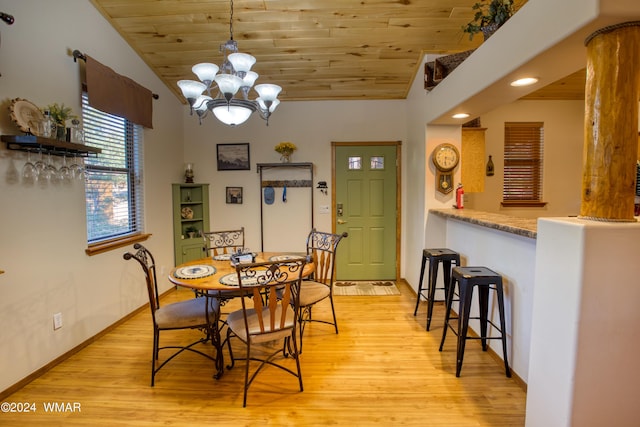 dining space with a notable chandelier, wood ceiling, vaulted ceiling, light wood-type flooring, and baseboards