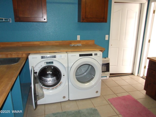 2124 W Vista Dr, Snowflake, AZ 85937 - laundry area featuring heating unit, cabinet space, light tile patterned floors, and washing machine and clothes dryer