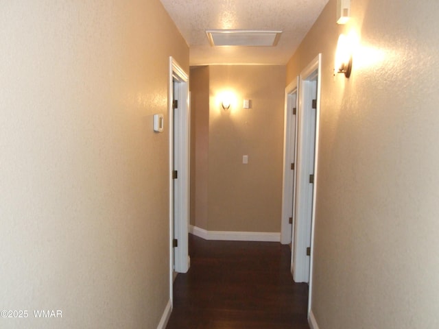 2124 W Vista Dr, Snowflake, AZ 85937 - hall featuring a textured ceiling, attic access, baseboards, wood finished floors, and visible vents