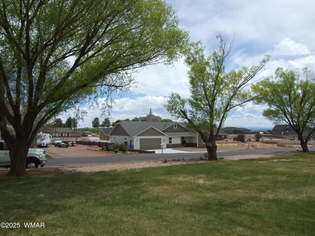 2124 W Vista Dr, Snowflake, AZ 85937 - view of front of house with an attached garage, a residential view, and a front yard