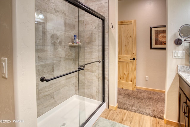 5863 Apollo Way, Lakeside, AZ 85929 - full bath featuring a stall shower, wood finished floors, baseboards, and vanity