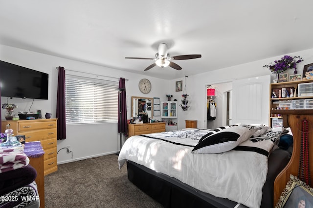 1275 Flag Hollow Rd, Lakeside, AZ 85929 - bedroom with dark colored carpet, a walk in closet, ceiling fan, baseboards, and a closet