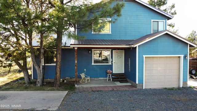 1275 Flag Hollow Rd, Lakeside, AZ 85929 - view of front of house with entry steps, metal roof, an attached garage, and fence