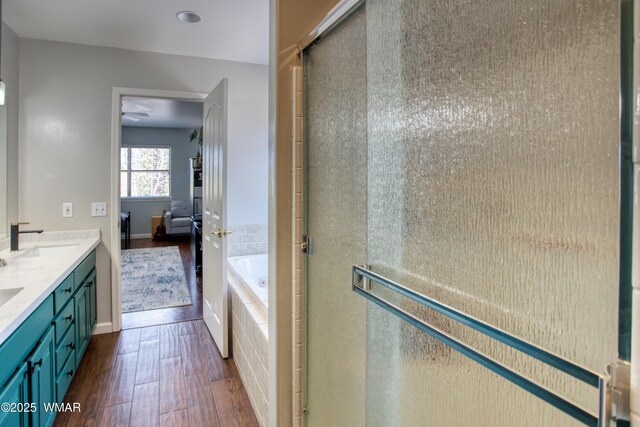 1421 N 36th Dr, Show Low, AZ 85901 - full bath featuring wood finished floors, a garden tub, double vanity, connected bathroom, and a shower stall