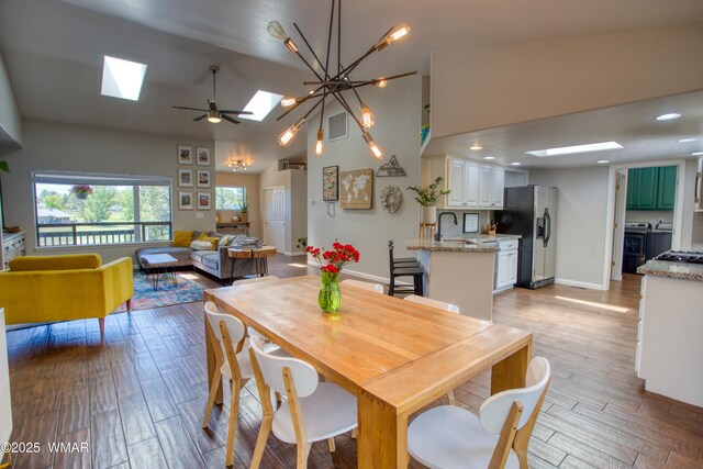 1421 N 36th Dr, Show Low, AZ 85901 - dining space with a skylight, separate washer and dryer, light wood-style flooring, baseboards, and ceiling fan