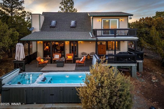 1513 Low Mountain Trl, Heber, AZ 85928 - back of house at dusk featuring a balcony, a deck, an outdoor living space, and a hot tub