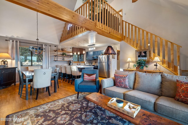 1513 Low Mountain Trl, Heber, AZ 85928 - living area with a notable chandelier, high vaulted ceiling, beam ceiling, stairway, and light wood finished floors