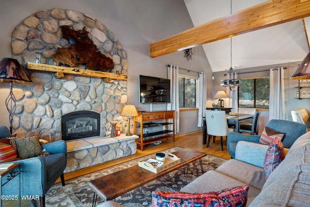 1513 Low Mountain Trl, Heber, AZ 85928 - living room with vaulted ceiling with beams, wood finished floors, a notable chandelier, and a stone fireplace