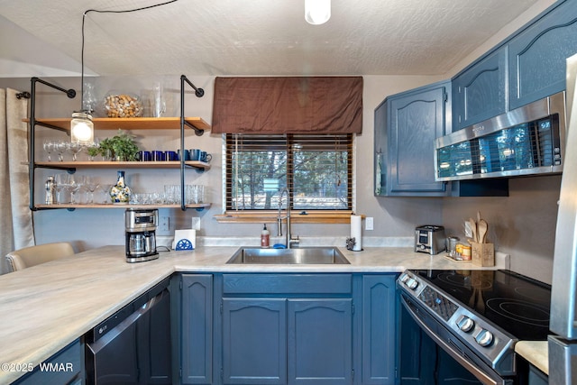 1513 Low Mountain Trl, Heber, AZ 85928 - kitchen with light countertops, a sink, blue cabinets, a textured ceiling, and stainless steel appliances