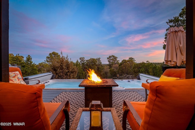 1513 Low Mountain Trl, Heber, AZ 85928 - pool at dusk with a hot tub and an outdoor living space with a fire pit
