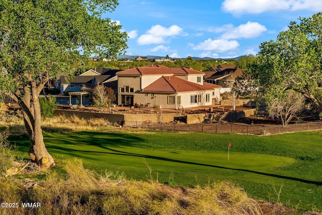 view of home's community featuring a mountain view and a putting area
