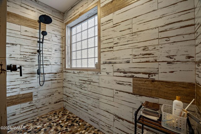 2737 Skyhawk Dr, Overgaard, AZ 85933 - full bathroom featuring wooden walls, a tile shower, and a healthy amount of sunlight