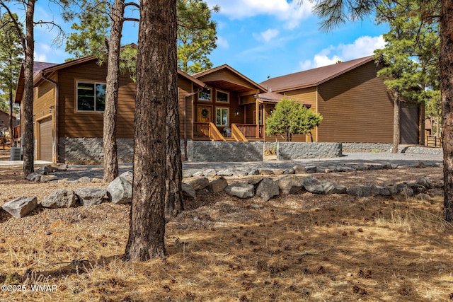 2737 Skyhawk Dr, Overgaard, AZ 85933 - rustic home featuring central AC unit and a garage