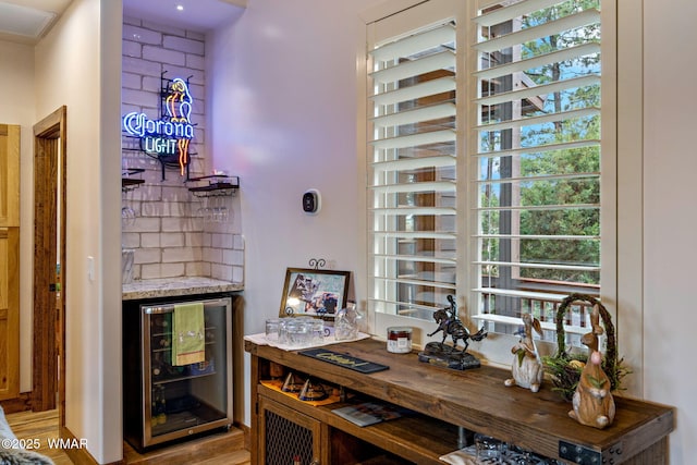 2737 Skyhawk Dr, Overgaard, AZ 85933 - bar with a healthy amount of sunlight, light wood finished floors, and wine cooler