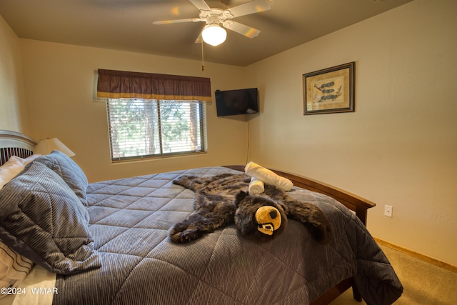 carpeted bedroom featuring a ceiling fan and baseboards