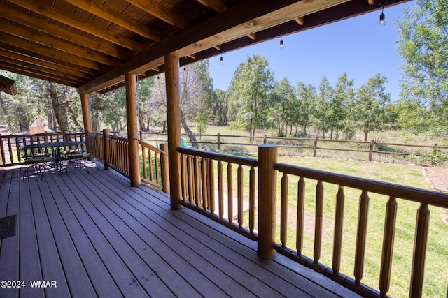 deck with a yard, outdoor dining space, and fence