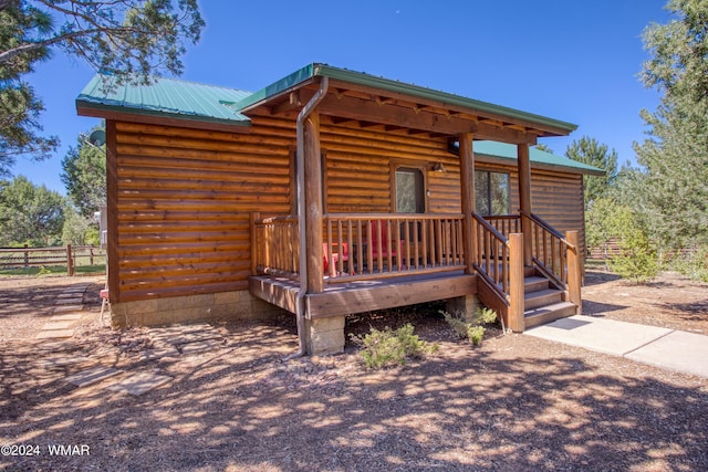 exterior space with metal roof and fence