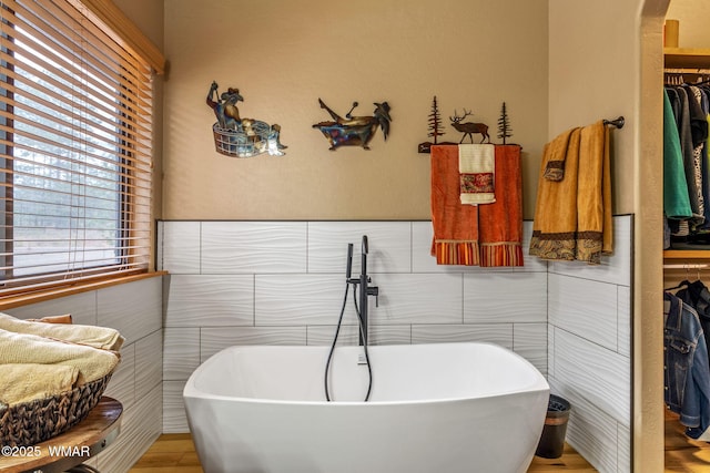 4602 Mountain Gate Cir, Lakeside, AZ 85929 - bathroom with a freestanding bath, tile walls, and a walk in closet