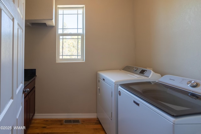 4701 S Manzanita Way, Show Low, AZ 85901 - laundry room featuring cabinet space, separate washer and dryer, wood finished floors, and baseboards